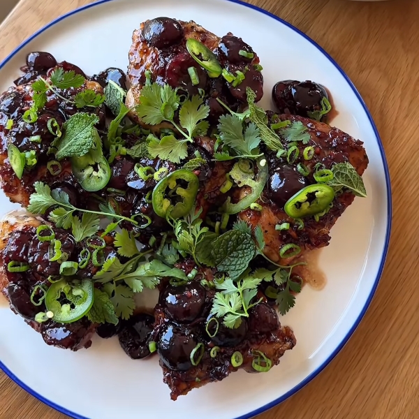 Sticky Cherry Chicken Thighs: A Dinner That’s Pure Magic 2 Juicy sticky cherry chicken thighs garnished with fresh herbs